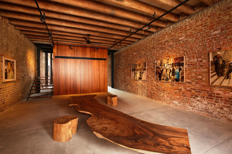 rustic-wooden-seat-also-ceiling-design-combined-with-exposed-brick-wall-and-art-paintings-decor