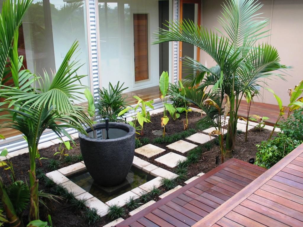 simple-garden-design-with-wooden-pattern-floor-and-green-foliages-idea